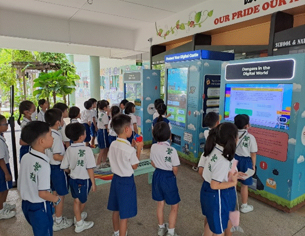 Pupils in PE attire queuing in front of 'Be Cuber Sage Pop-up' at courtyard.